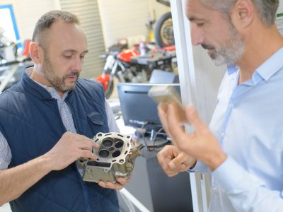 mechanic holding a piece to change